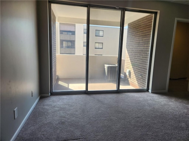 unfurnished room featuring carpet and baseboards