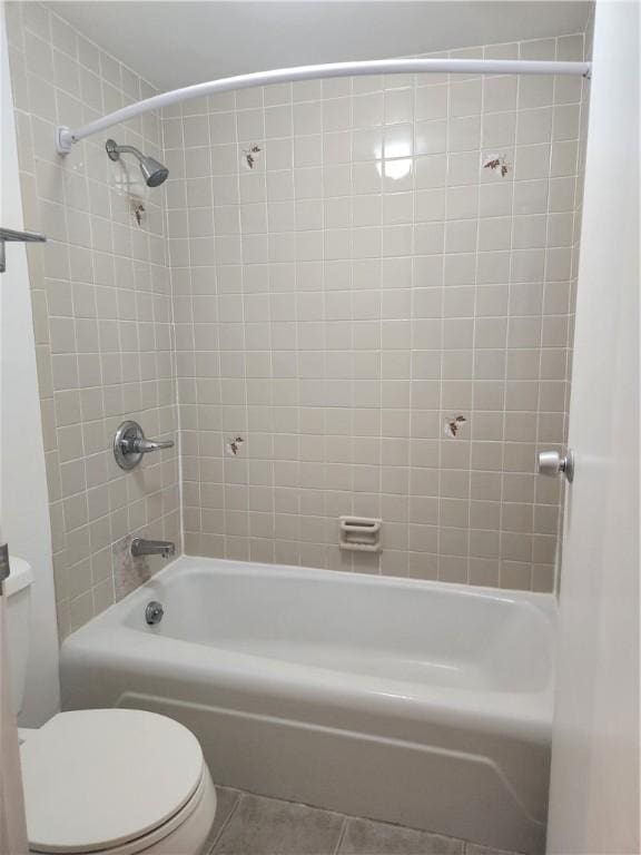 full bathroom with shower / bath combination, toilet, and tile patterned floors