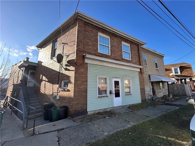 back of house featuring brick siding