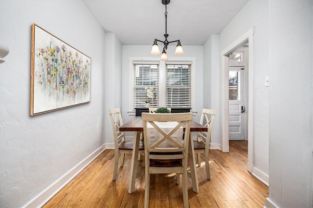 dining area with light wood-style flooring and baseboards