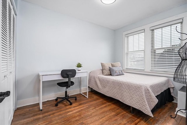 bedroom with baseboards and wood finished floors