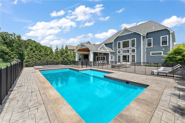 view of swimming pool featuring a patio area, a fenced backyard, and a fenced in pool