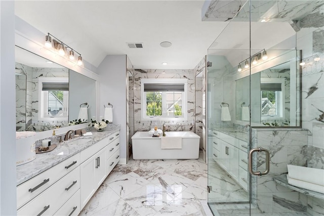 bathroom with marble finish floor, plenty of natural light, a marble finish shower, and vanity