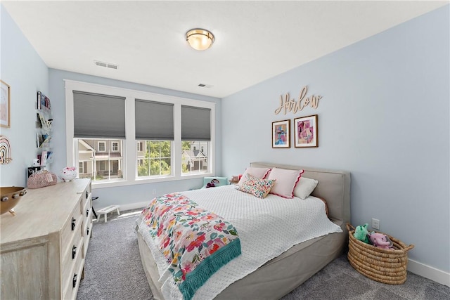 carpeted bedroom featuring baseboards and visible vents