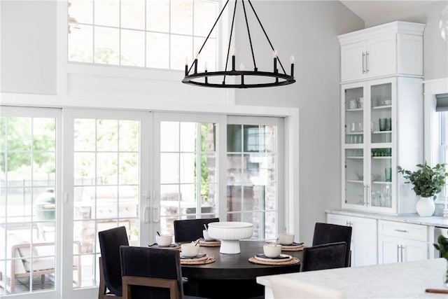 dining room with french doors and an inviting chandelier