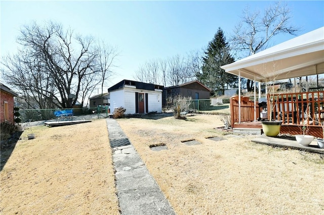 view of yard featuring an outbuilding and fence