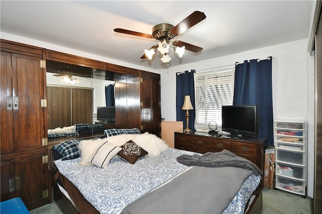 bedroom featuring dark colored carpet and ceiling fan