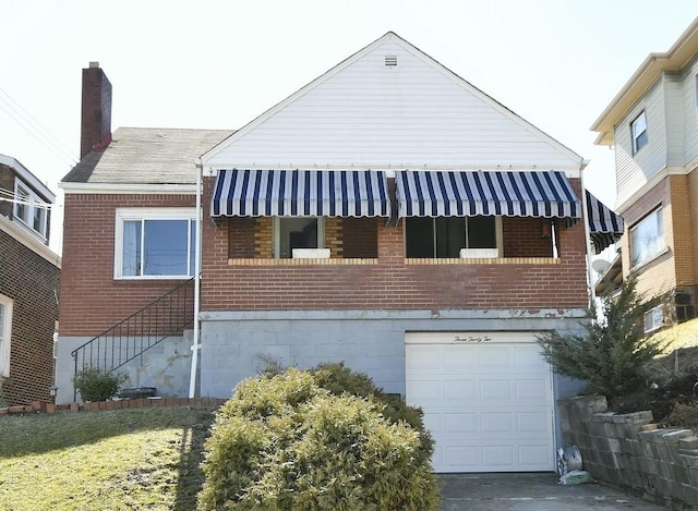 view of home's exterior with a garage, brick siding, and a chimney