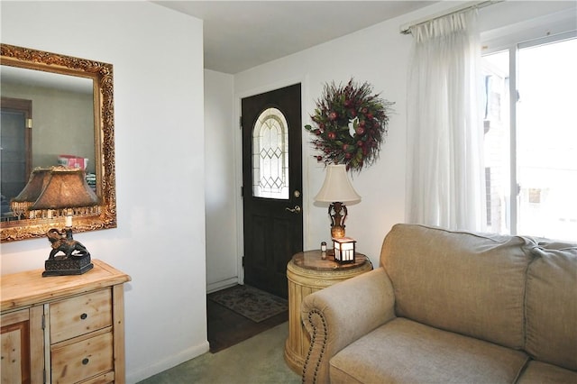 entrance foyer with carpet floors and baseboards