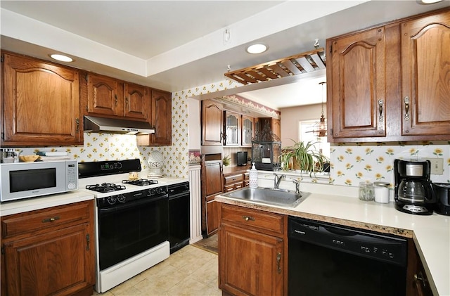 kitchen with white microwave, under cabinet range hood, a sink, dishwasher, and gas range