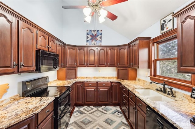 kitchen with vaulted ceiling, black appliances, light stone counters, and a sink