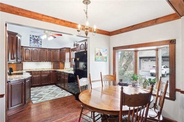 dining room featuring ceiling fan with notable chandelier and wood finished floors