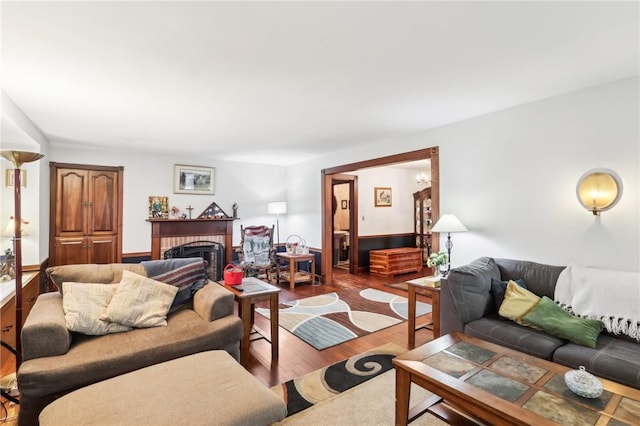 living room with a fireplace and wood finished floors