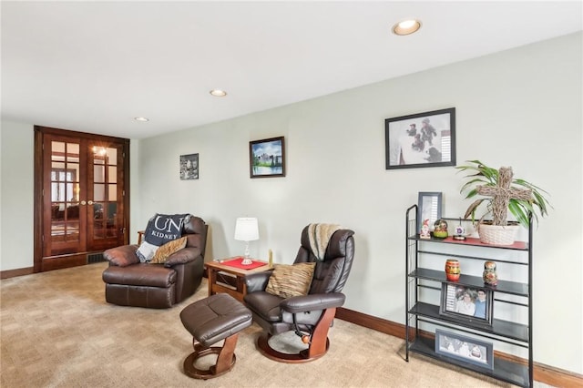 sitting room featuring french doors, carpet, recessed lighting, and baseboards