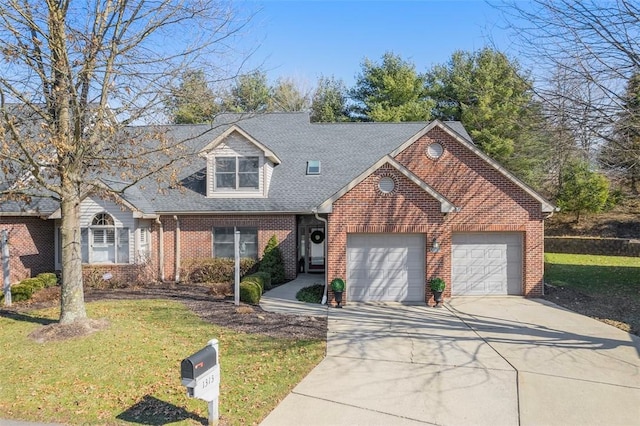 view of front facade featuring an attached garage, brick siding, driveway, and a front yard