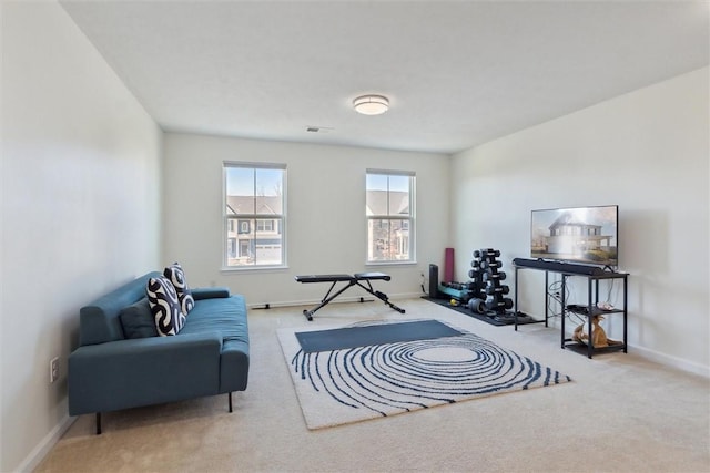 sitting room with visible vents, baseboards, and carpet flooring