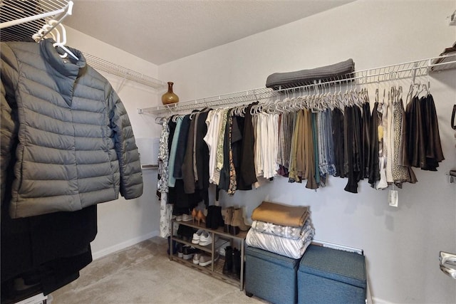 walk in closet with carpet