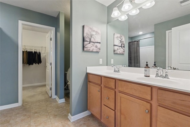 full bathroom featuring double vanity, visible vents, toilet, and a sink