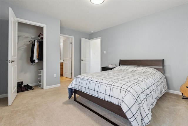 carpeted bedroom featuring a closet and baseboards