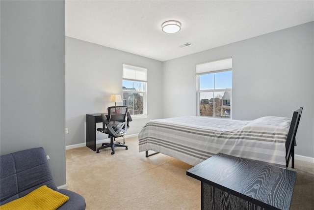 carpeted bedroom with visible vents and baseboards