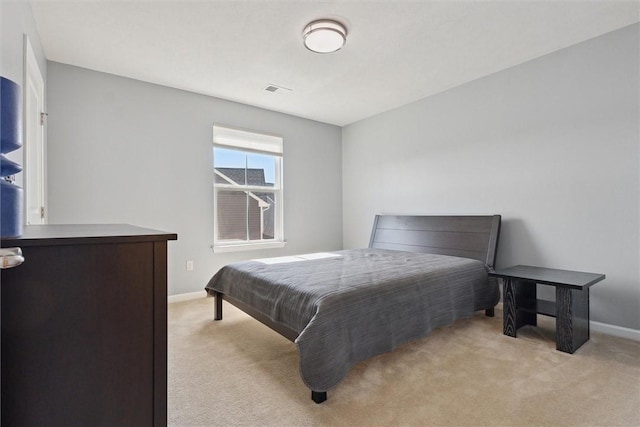 bedroom with light carpet, visible vents, and baseboards