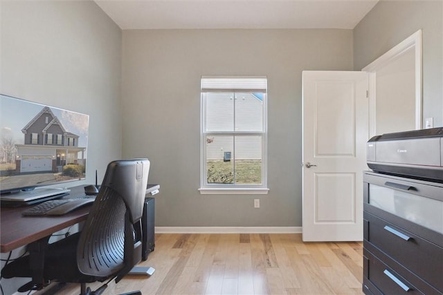 office area with baseboards and light wood-style floors