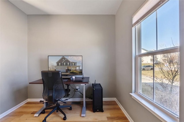 office space featuring light wood-style flooring and baseboards