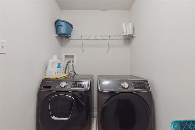 clothes washing area featuring laundry area and separate washer and dryer