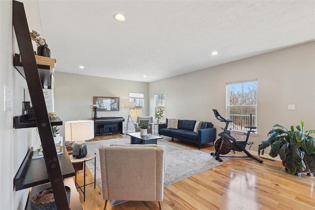 living area with recessed lighting, plenty of natural light, and wood finished floors