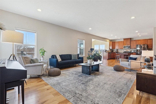 living room featuring light wood-style flooring and recessed lighting