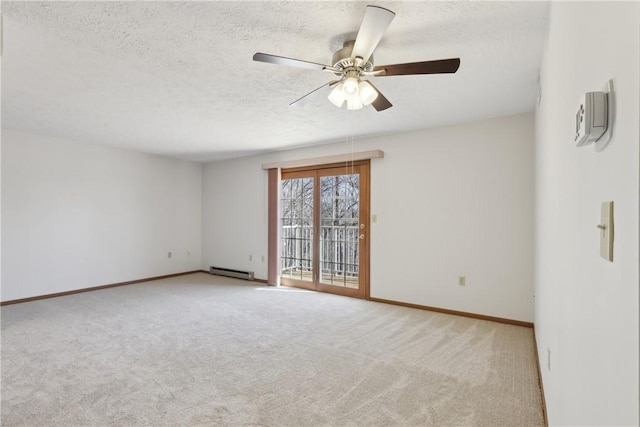 carpeted spare room featuring a ceiling fan, baseboards, baseboard heating, and a textured ceiling