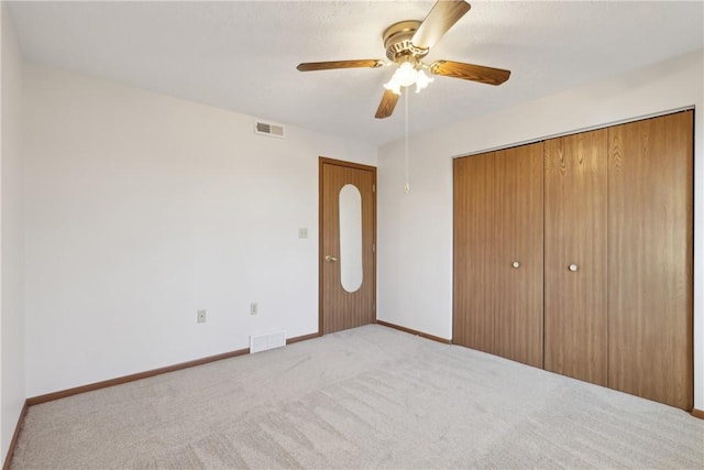 unfurnished bedroom with baseboards, visible vents, and a closet