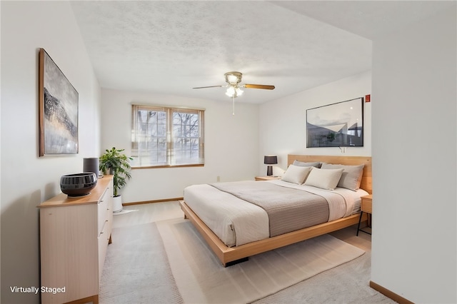 carpeted bedroom featuring baseboards and a textured ceiling