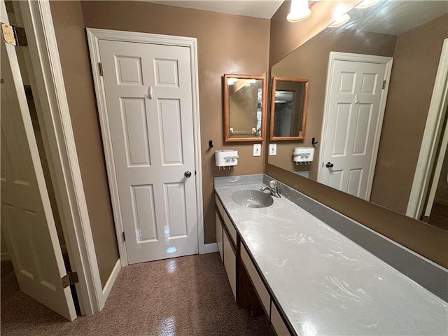 bathroom with vanity and baseboards