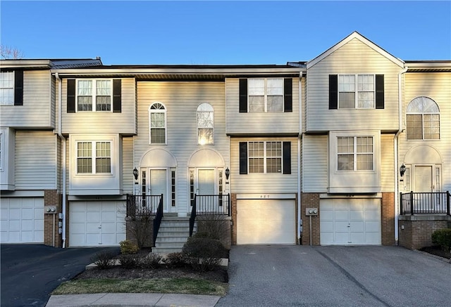 view of front of house with brick siding, driveway, and an attached garage