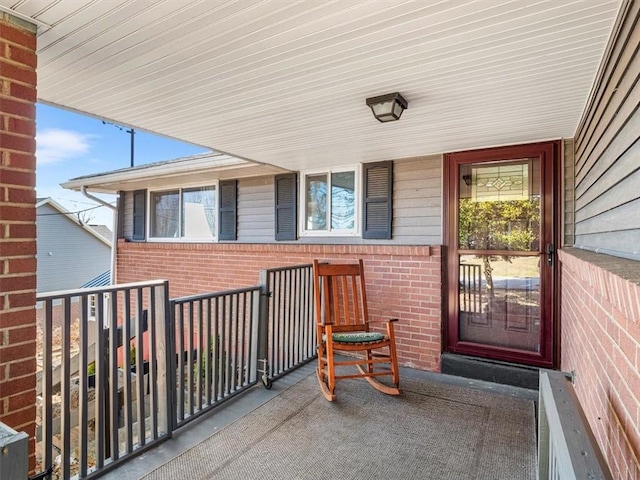 entrance to property featuring brick siding