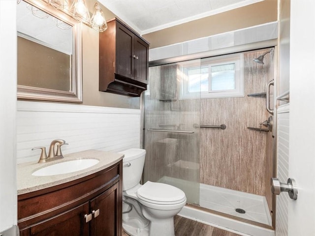 full bath with toilet, a stall shower, wood finished floors, and vanity