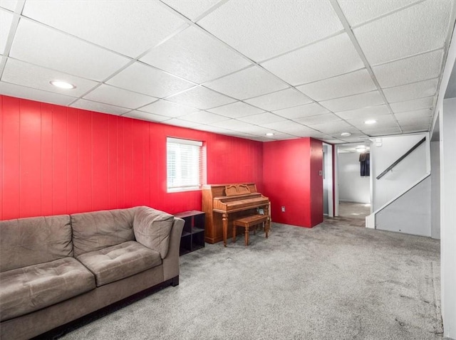 carpeted living room featuring a paneled ceiling