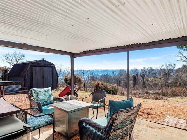 view of patio / terrace featuring a storage shed, outdoor lounge area, and an outbuilding