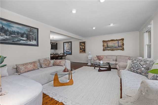 living area with crown molding and wood finished floors