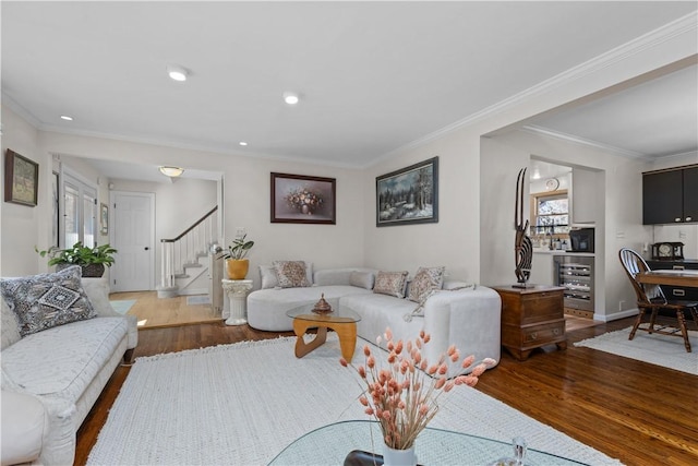 living area featuring recessed lighting, ornamental molding, stairs, and wood finished floors