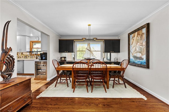 dining area with wood finished floors, beverage cooler, and crown molding