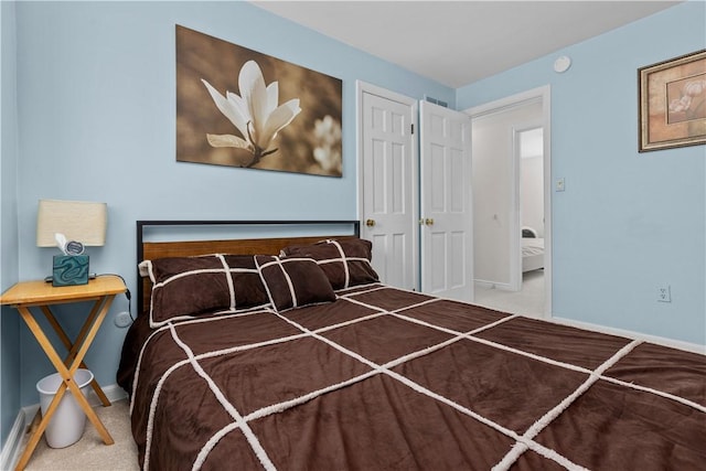 carpeted bedroom featuring baseboards