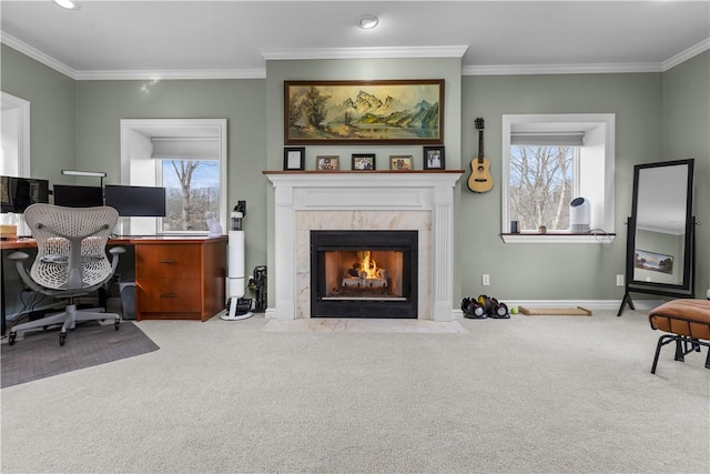 carpeted home office with baseboards, a tiled fireplace, and crown molding