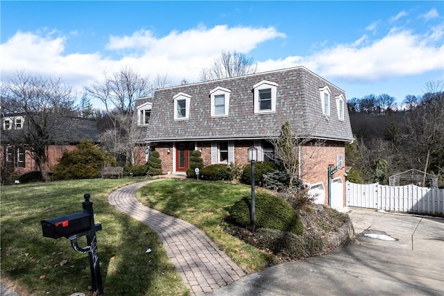 1921 Garrick Dr, Churchill Boro, PA 15235 - front facade with mansard roof, a gate, brick siding, and concrete driveway