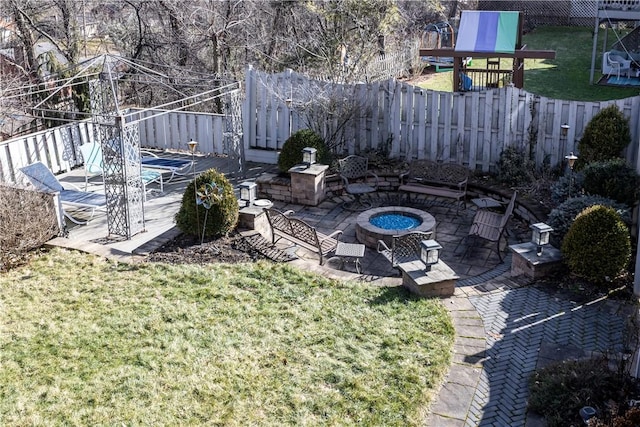 view of yard featuring a patio, a fenced backyard, and an outdoor fire pit