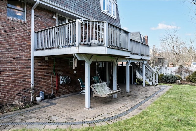 1921 Garrick Dr, Churchill Boro, PA 15235 - back of property with a patio, a wooden deck, stairway, and brick siding