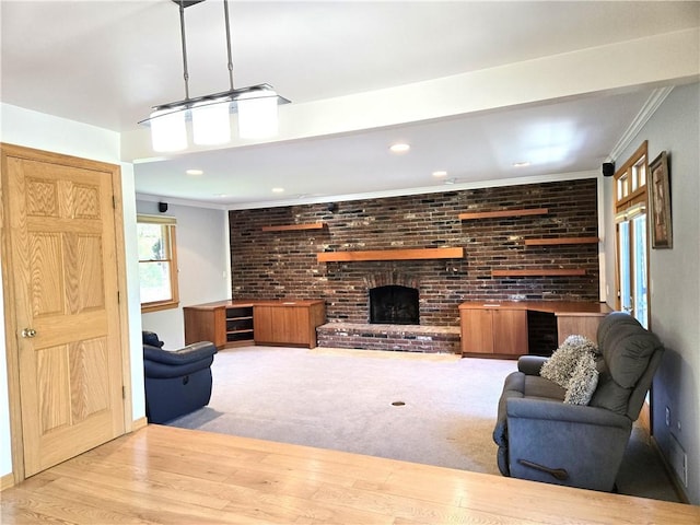 1921 Garrick Dr, Churchill Boro, PA 15235 - carpeted living area featuring a brick fireplace, ornamental molding, recessed lighting, and brick wall