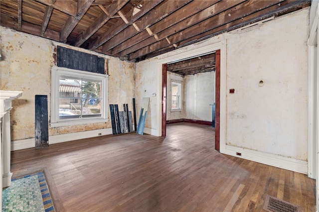 interior space with visible vents, plenty of natural light, wood finished floors, and a fireplace