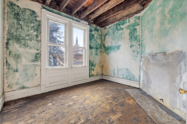 unfurnished room with wood-type flooring